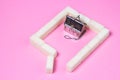 House-shaped tea strainer on a pink background. Tea strainer with sugar cubes. Refined sugar. Small house. Brewing tea.