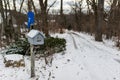 A house shaped wooden mailbox covered with snow, winter scene