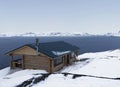 House on the shore of the sea bay, in the window of which a polar bear looks in, polar region