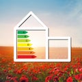 House with the sign of energy saving on a background field with Royalty Free Stock Photo