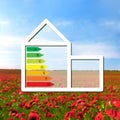 House with the sign of energy saving on a background field with Royalty Free Stock Photo