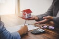 House signers signing signature loan document to home ownership with real estate agents ownership. Mortgage and real estate Royalty Free Stock Photo