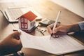 House signers signing signature loan document to home ownership with real estate agents ownership. Mortgage and real estate Royalty Free Stock Photo