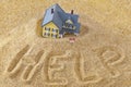 House sinking in quick sand with for rent sign and word help written in sand Royalty Free Stock Photo