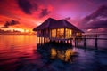 House Sitting Atop Body of Water, Tranquil and Serene Home by the Lake, Water bungalow, Sunset on the islands of the Maldives, A Royalty Free Stock Photo