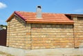 House small cabin construction with red clay roof, pumice chimney and limestone wall