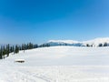 A house in snow valley with beautiful background of pines, hills Royalty Free Stock Photo