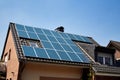 House with solar panel system on roof in Germany. Photovoltaic solar system on a roof surface. Installed sun collectors on a top Royalty Free Stock Photo