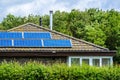 A house with a solar panels panels installed on the tile roof Royalty Free Stock Photo