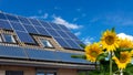 House with solar panels and sunflowers in the garden Royalty Free Stock Photo