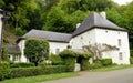 House with some ivy in facade and a vineyard. Royalty Free Stock Photo