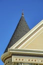 House spire or turrent on home or structure in the neighborhood with beige wood pannels and white accent paint Royalty Free Stock Photo