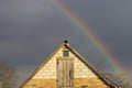 house and spring rainbow on blue sky