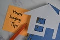 House Staging Tips write on sticky notes isolated on office desk