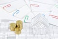 House and step gold coins have paperwork with colorful paperclip Royalty Free Stock Photo