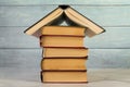 house structure made with vintage books against wooden wall. High quality photo Royalty Free Stock Photo
