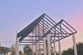House structure under construction steel roof truss house pillar blue and orange background