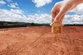 House symbol with location pin and Empty dry cracked swamp reclamation soil