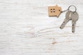 House symbol with silver keys on wood. Real estate concept Royalty Free Stock Photo