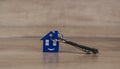 House symbol with silver keys on wood. Real estate concept Royalty Free Stock Photo