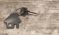 House symbol with silver keys on wood. Real estate concept Royalty Free Stock Photo