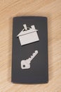 House tag and key on a smartphone Royalty Free Stock Photo