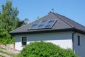 House with tiled roof and solar thermal power plant Royalty Free Stock Photo