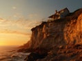 House on top of the mountain. Lonely house over a cliff in the rays of the rising sun. Cottage on a high hill near water Royalty Free Stock Photo