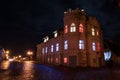 House with a tower with lights on the windows in different colors. Day of proclamation of the Republic of Latvia