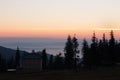 House and trees silhouettes on clear morning sky background. Village silhouette in mountains at dawn with copy space.