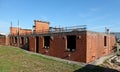 House under construction with only the first floor finished and the bricks exposed. Royalty Free Stock Photo