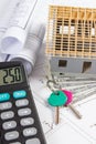 House under construction, keys, calculator, currencies dollar and electrical drawings, concept of building home Royalty Free Stock Photo