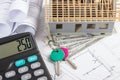 House under construction, keys, calculator, currencies dollar and electrical drawings, concept of building home Royalty Free Stock Photo