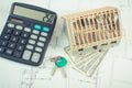 House under construction, keys, calculator and currencies dollar on electrical drawings and diagrams Royalty Free Stock Photo