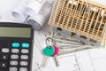 House under construction, keys, calculator and currencies dollar on electrical drawings Royalty Free Stock Photo