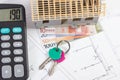 House under construction, keys, calculator and currencies euro on electrical drawings, concept of building home Royalty Free Stock Photo