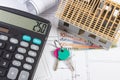 House under construction, keys, calculator, currencies euro and electrical drawings, concept of building home Royalty Free Stock Photo