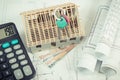 House under construction, keys, calculator and currencies euro on electrical drawings and diagrams Royalty Free Stock Photo