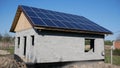 House under construction with solar panels on the roof. Alternative energy. Solar cells generate energy. Independent home Royalty Free Stock Photo