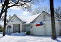 House under snow with Texas flag