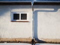 House wall with rain gutter and downpipe