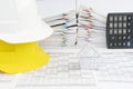 House and white on yellow engineer hat on finance account Royalty Free Stock Photo