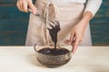 House wife wearing apron making. Steps of making cooking chocolate cake. Preparing dough, mixing ingredients Royalty Free Stock Photo