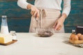 House wife wearing apron making. Steps of making cooking chocolate cake. Preparing dough, mixing ingredients Royalty Free Stock Photo