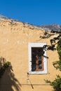 House with a window and hill in the background, Crete, Greece