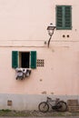 House with windows with shutter and a bicycle Royalty Free Stock Photo