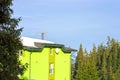 House in winter against the background of fir trees Royalty Free Stock Photo