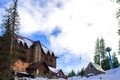 House in winter against the background of fir trees Royalty Free Stock Photo