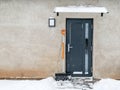 House wooden entrance door. Snow and ice. Exterior of the building Royalty Free Stock Photo