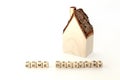 House wooden model with `home delivery` written nearby on white background and copy space. Royalty Free Stock Photo